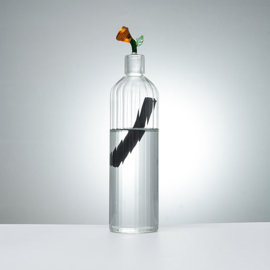 clear glass carafe and glass with orange flower stopper for elegant beverage serving